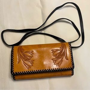 Tan and black embossed leather crossbody bag